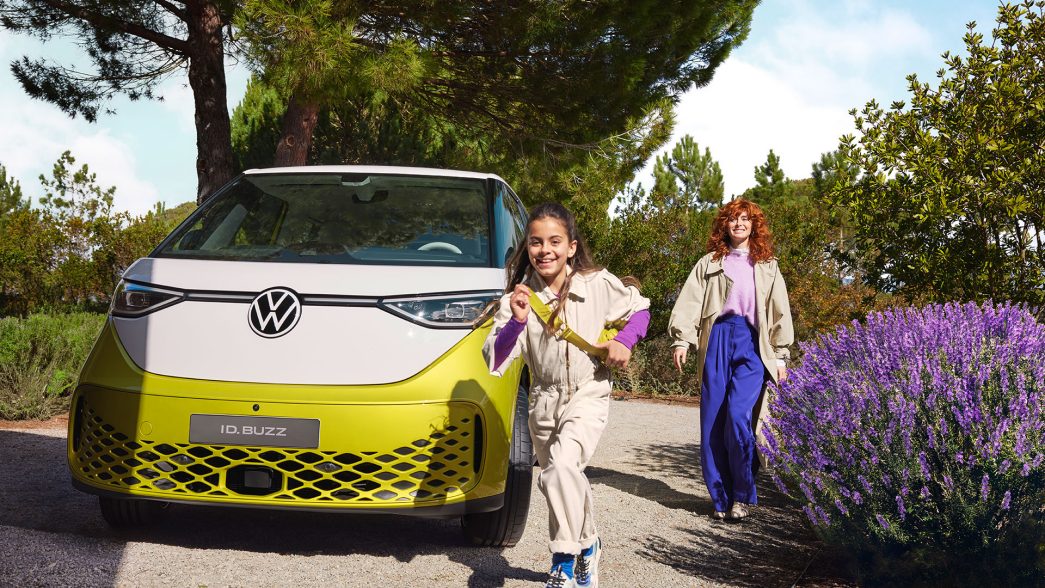 AMAG der VW ID. Buzz in weiss gelb, Front mit Frau und Mädchen daneben